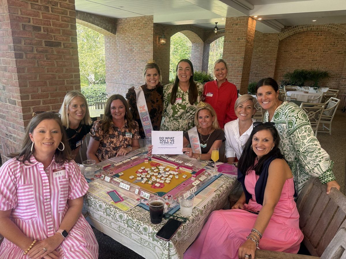 Mahj For A Cause group playing mahjong on a covered patio